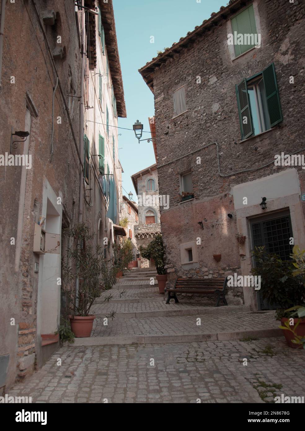 A vertical shot of a narrow street with old residential buildings in ...