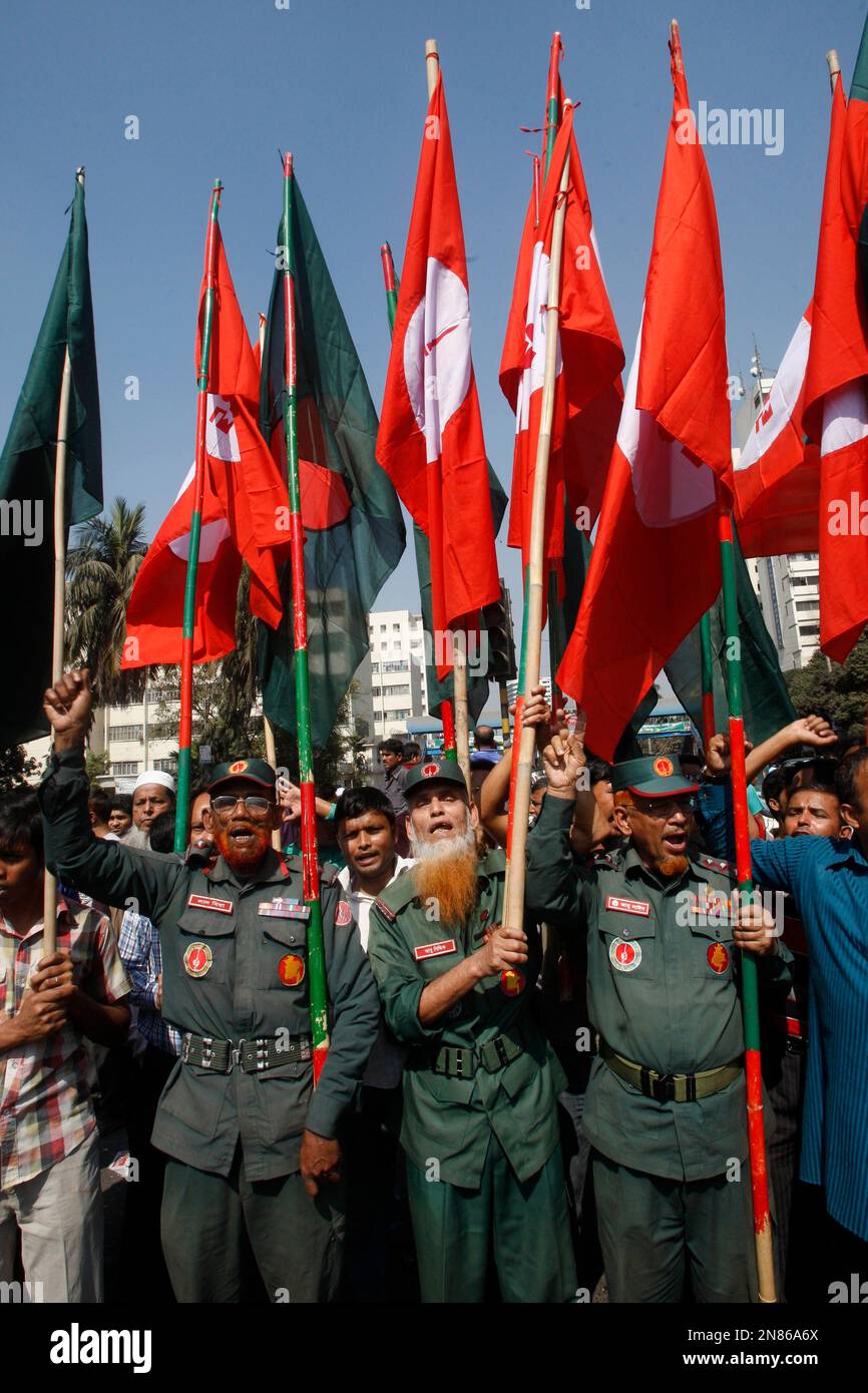Bangladesh's veteran freedom fighters wave their flags, red, along with Bangladeshi flags as they march demanding death penalty for Jamaat-e-Islami, leader Abdul Quader Mollah in Dhaka, Bangladesh, Wednesday, Feb. 6, 2013. The leader of Bangladesh's largest Islamic party was Tuesday convicted and sentenced to life in prison in a series of killings during the country's 1971 independence war. (AP Photo/Pavel Rahman) Stock Photo