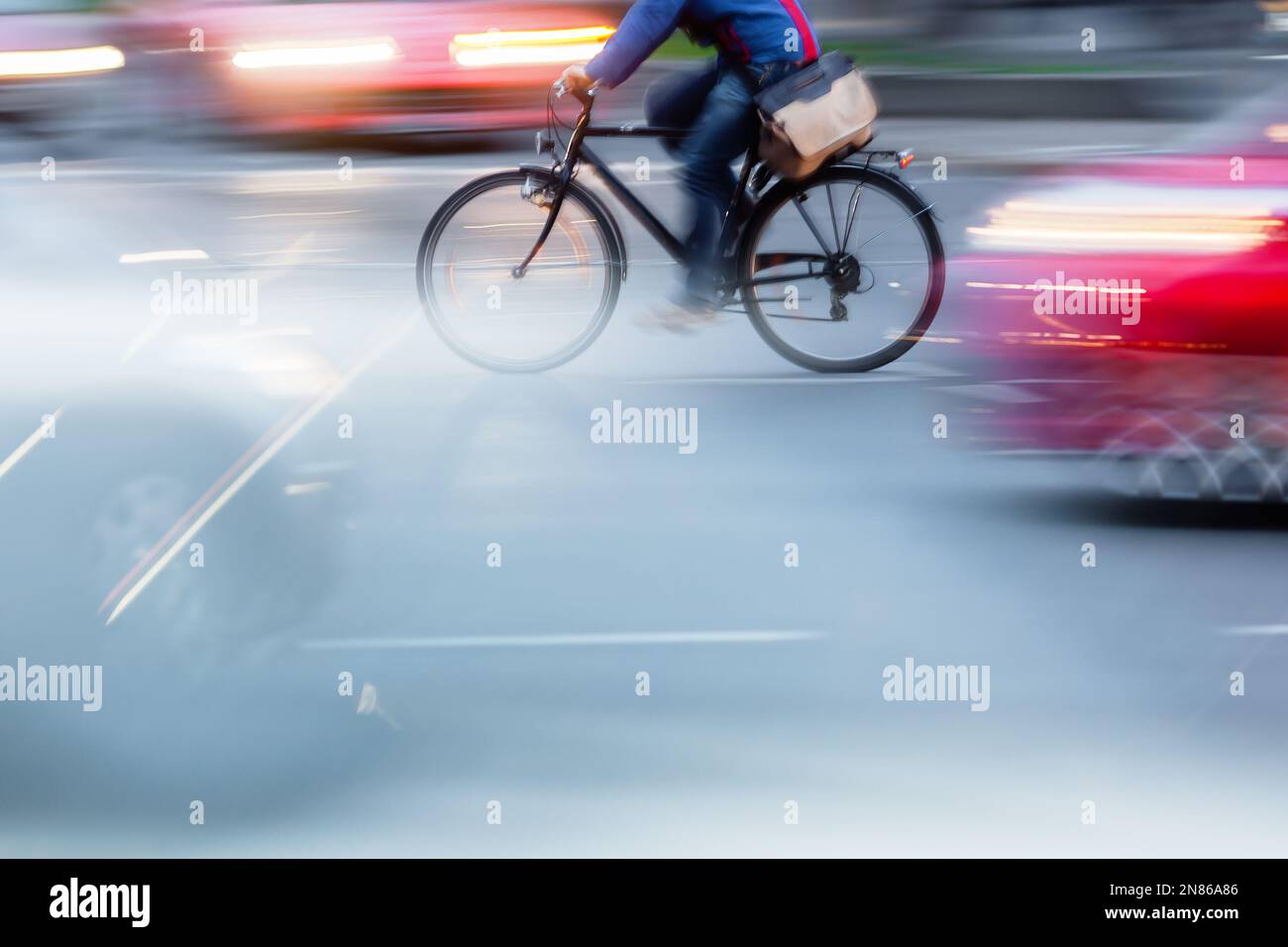 bicycle rider in city traffic with camera motion blur effect Stock ...