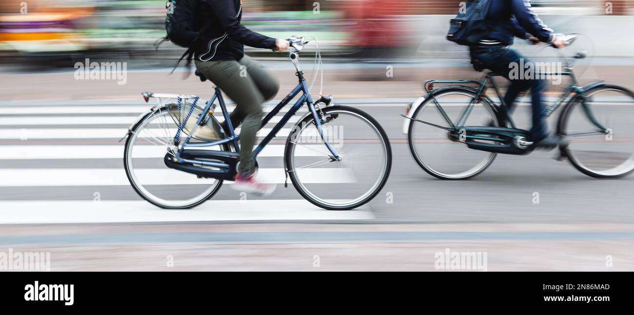 picture with camera made motion blur effect of bicycle riders on a city ...