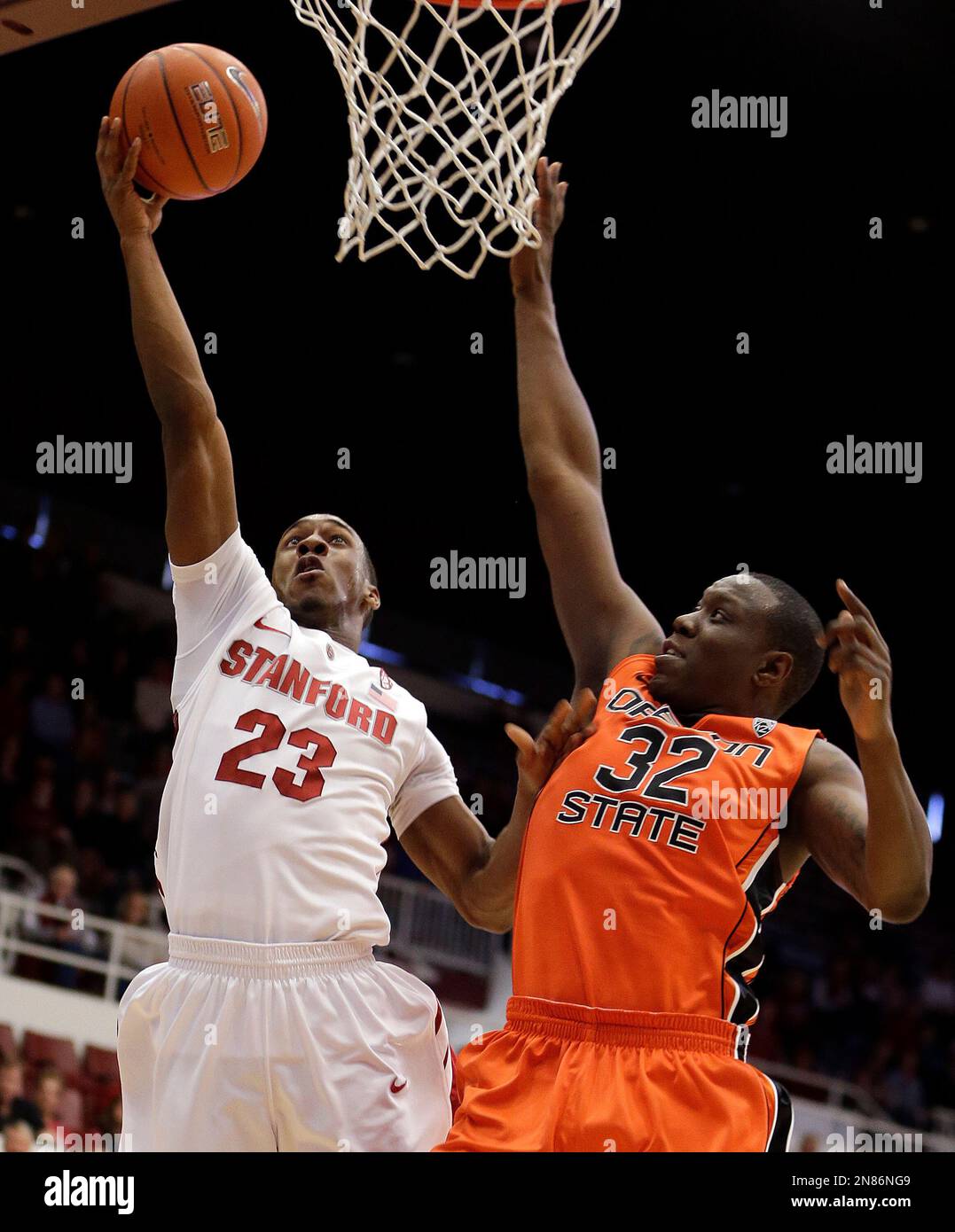 Stanford's Gabriel Harris, left, lays up a shot against Oregon State's