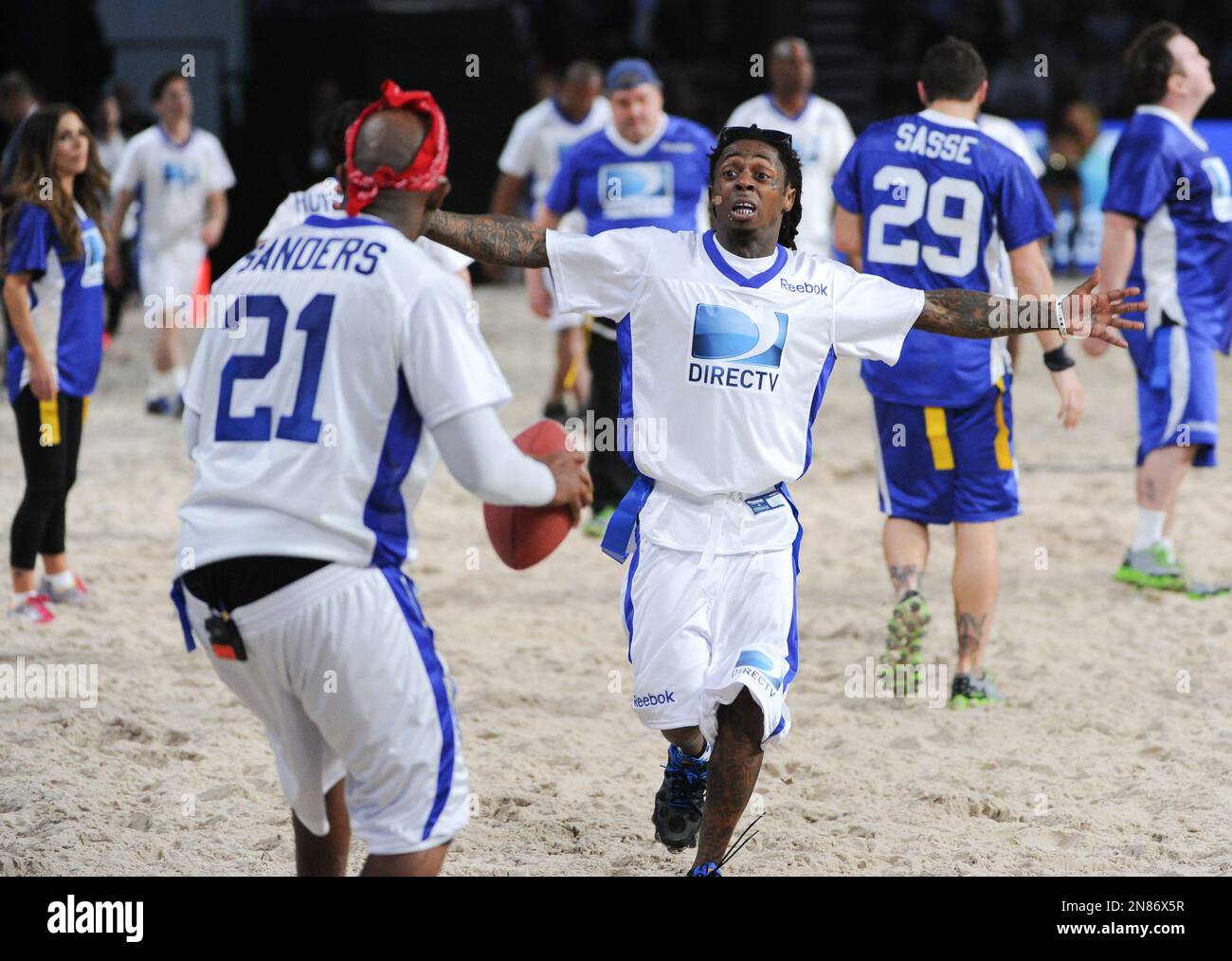 Rapper Lil Wayne running to congratulate Deion Sanders in Directv's ...