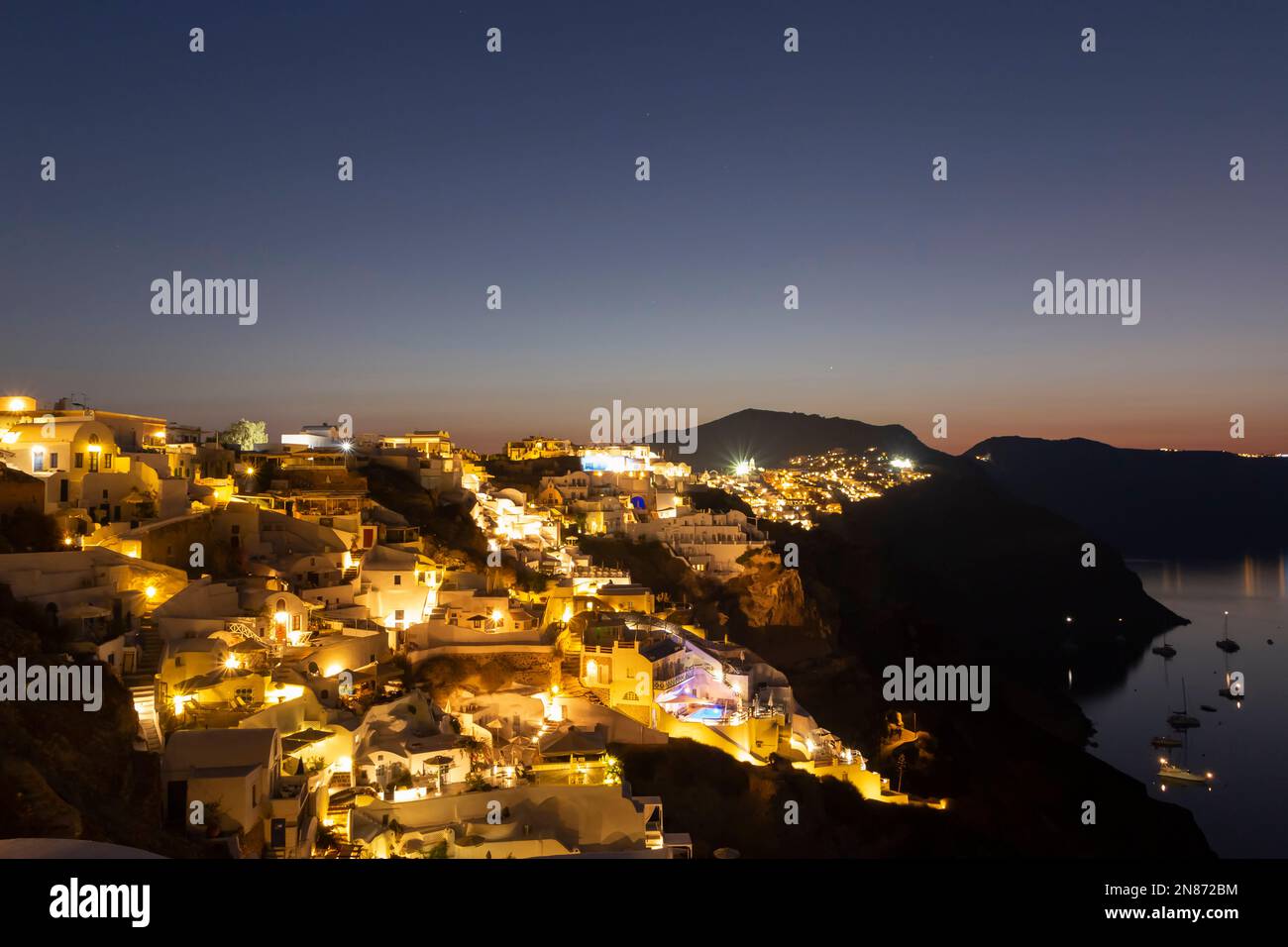 view of Oia village on Santorini island in Greece at sunset Stock Photo