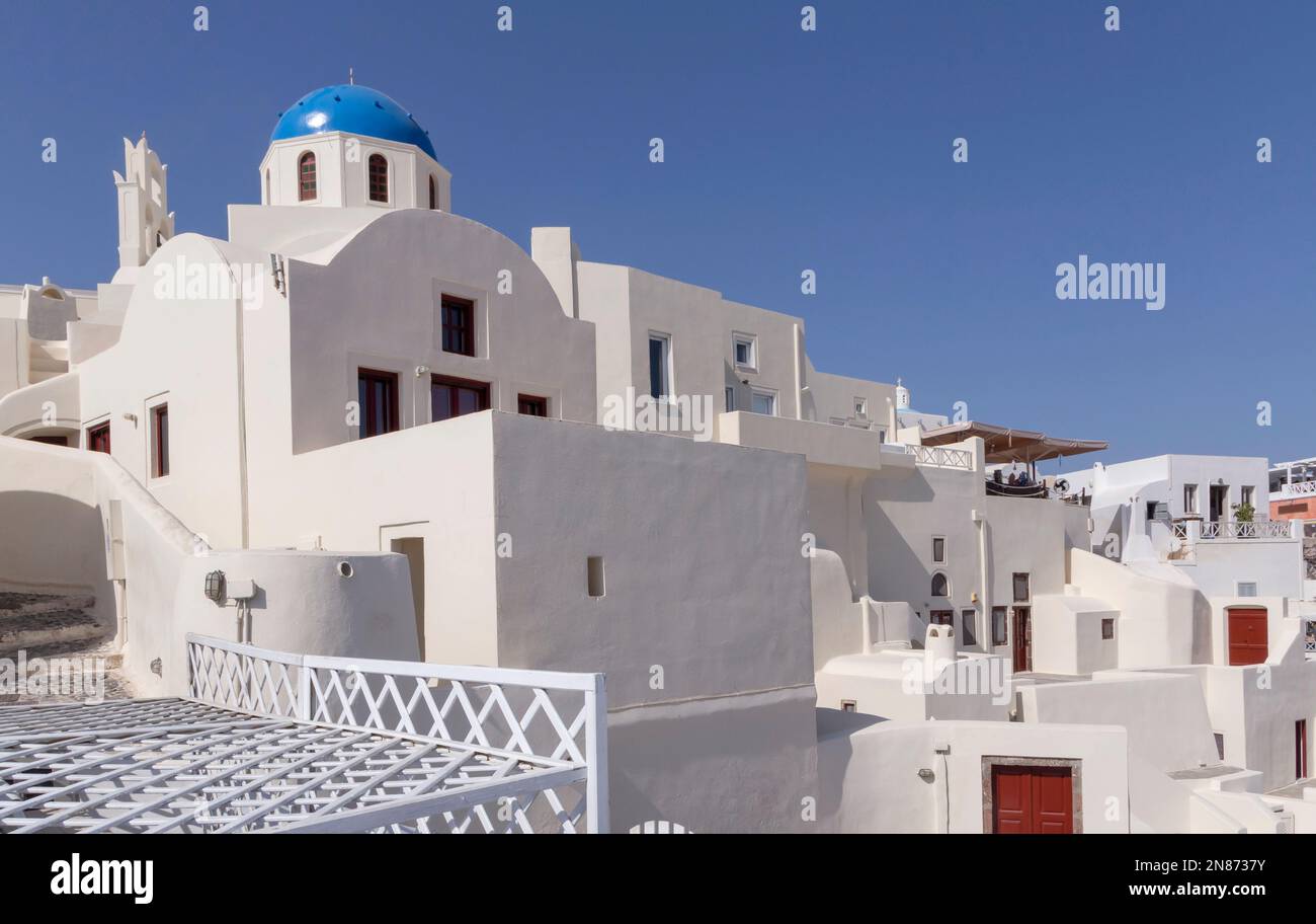 whitewashed houses and chapel in Oia village on Santorini island in Greece Stock Photo