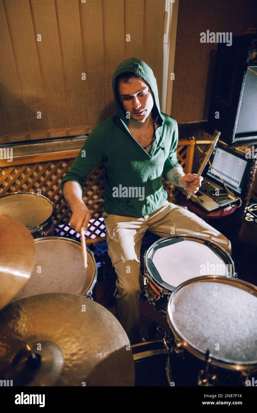 Drummer playing on drum set in recording studio Stock Photo - Alamy
