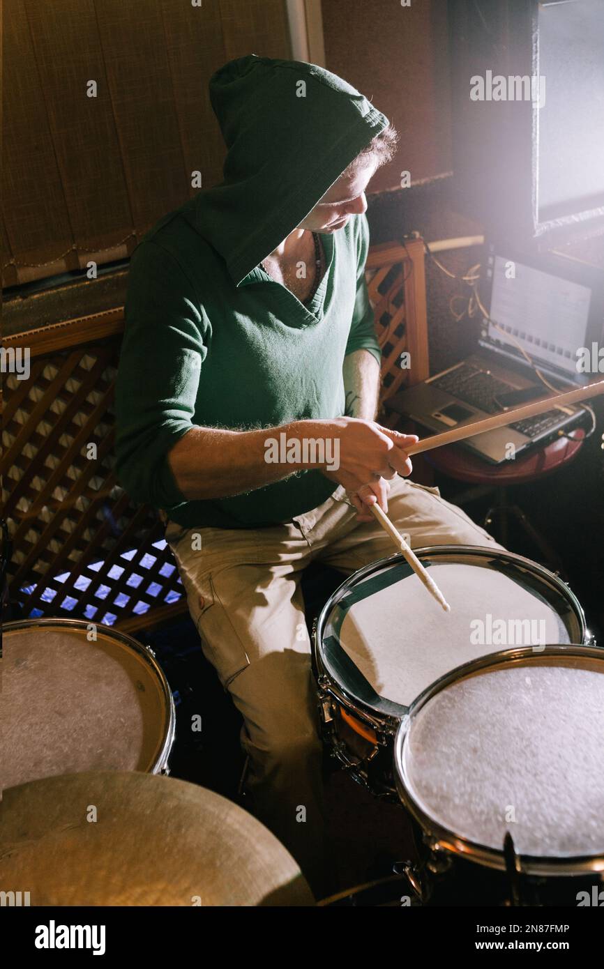 Drummer recording drums in music studio Stock Photo