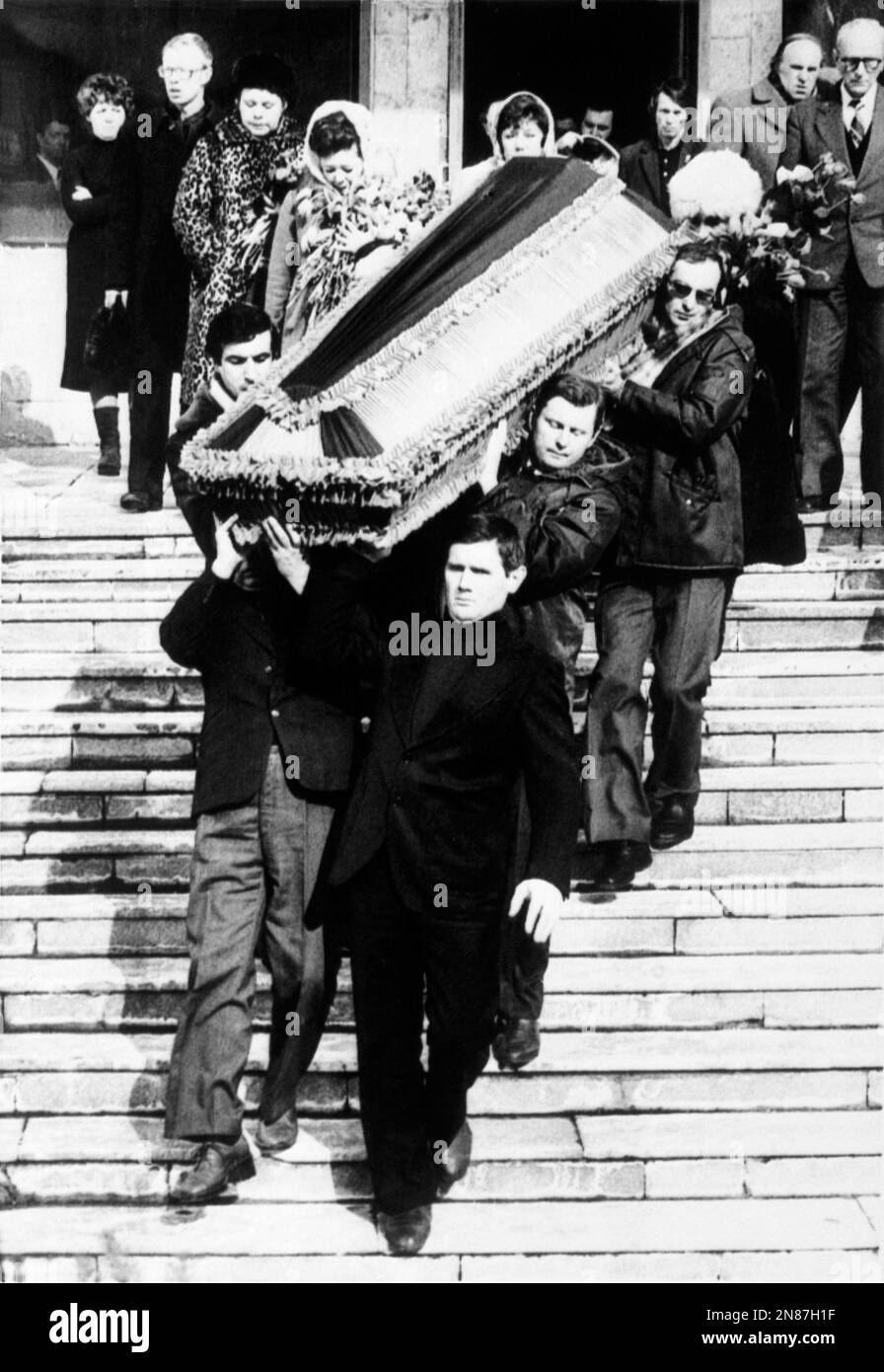 Pallbearers carry the coffin with the body of former British diplomat ...