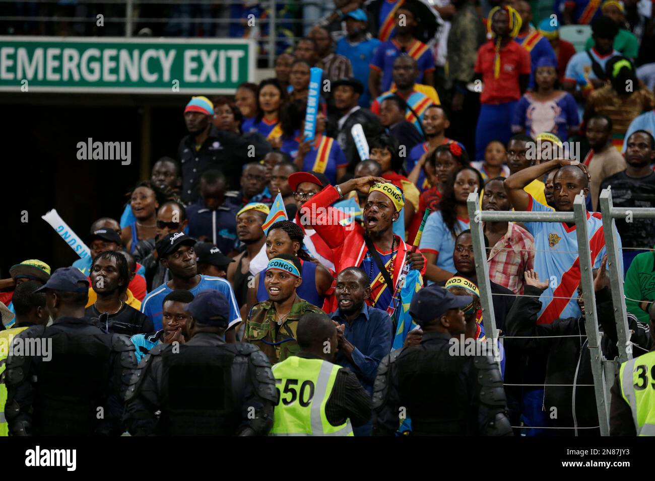 Congo fans, watched over by a line of South African police in riot gear ...