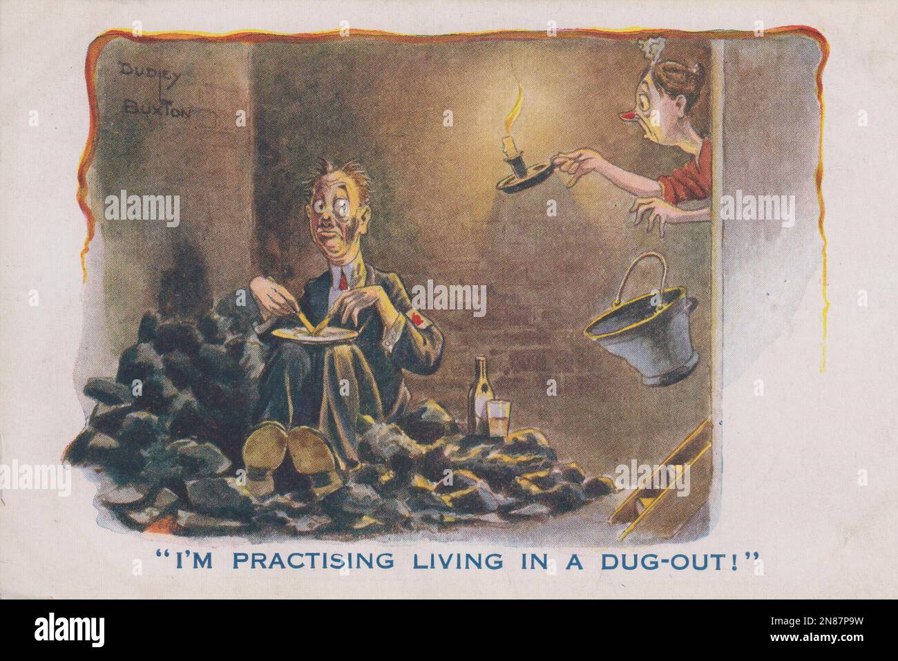 'I'm practising living in a dug-out!': First World War cartoon by Dudley Buxton. It shows a middle aged man sitting on a pile of coal in his cellar, eating his dinner with a bottle of beer next to him. His face is smudged with coal dust. An astonished servant has just found him, by the light of a handheld candle, and has just dropped the coal scuttle. The cartoon is on a postcard which was sent in 1916, after the passing of the Military Service Act and the introduction of compulsory conscription Stock Photo