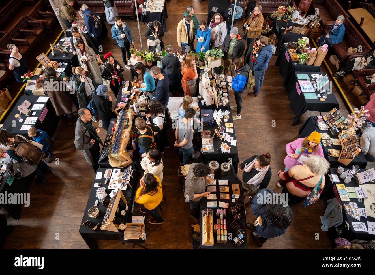 Cambridge, UK. 11th Feb, 2023. People enjoy the Cambridge Chocolate Festival in the historic Cambridge University Union Society Debating Chamber. The two day event includes tastings, talks and stallholders selling artisan chocolates. Credit: Julian Eales/Alamy Live News Stock Photo