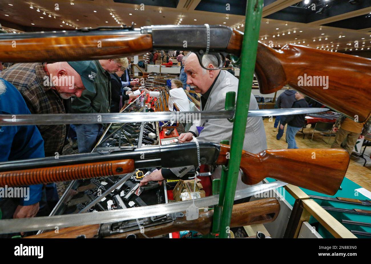 Gun store owner David Petronis, of Mechanicville, N.Y., right, talks