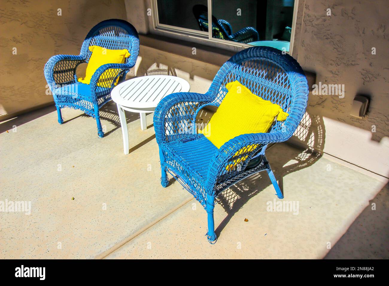 Two Blue Wicker Arm Chairs And Table On Front Porch Stock Photo - Alamy