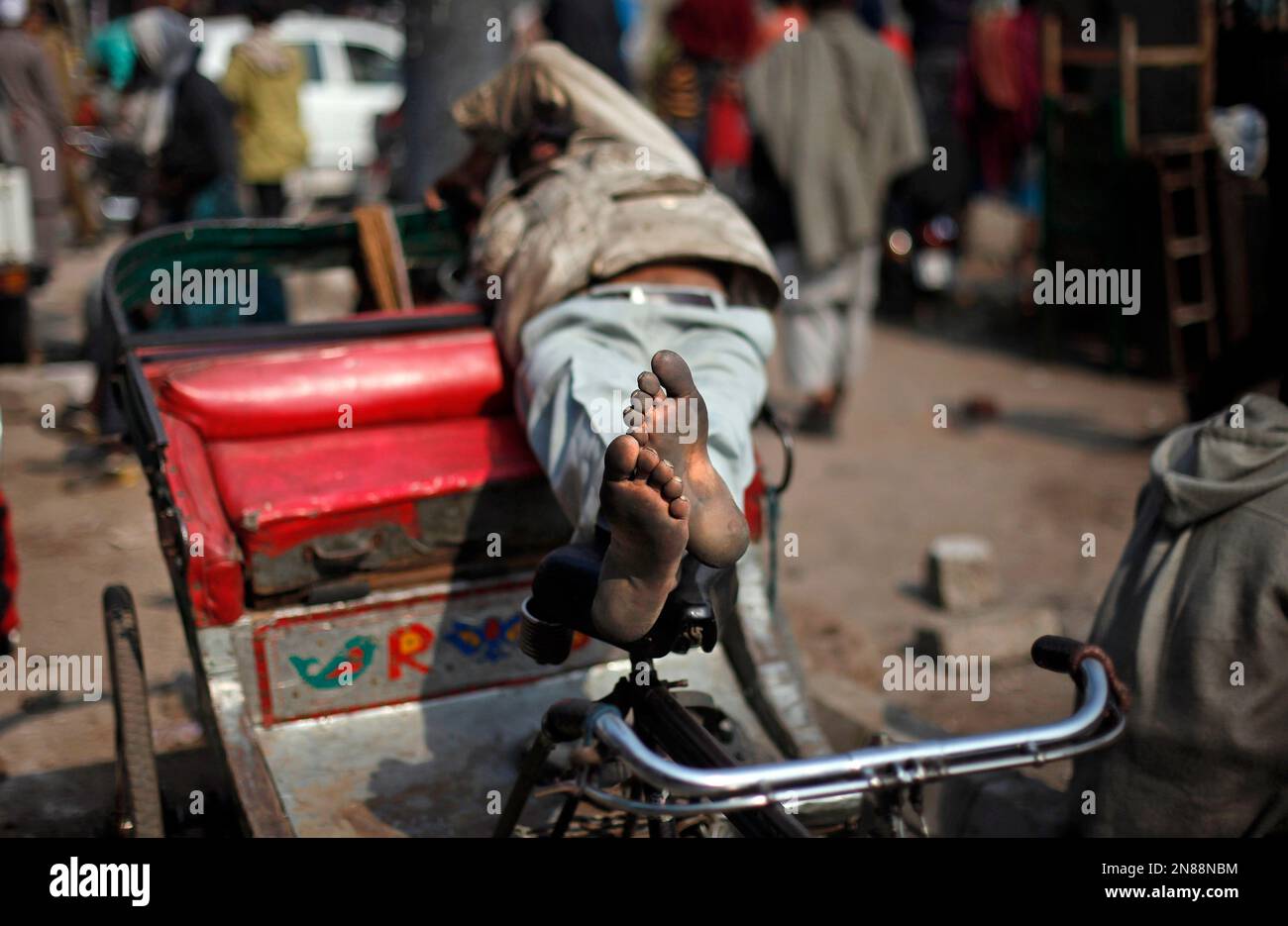 Altaf Rickshwa A rickshaw puller rests on his rickshaw as traffic is blocked by police ...