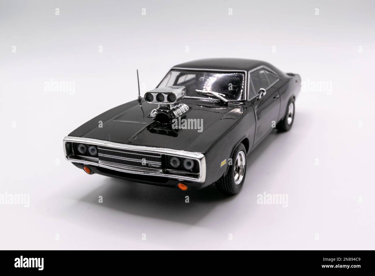 Fast&Furious Dodge Charger R/T (1970) 143 model car, front view, white background Stock Photo