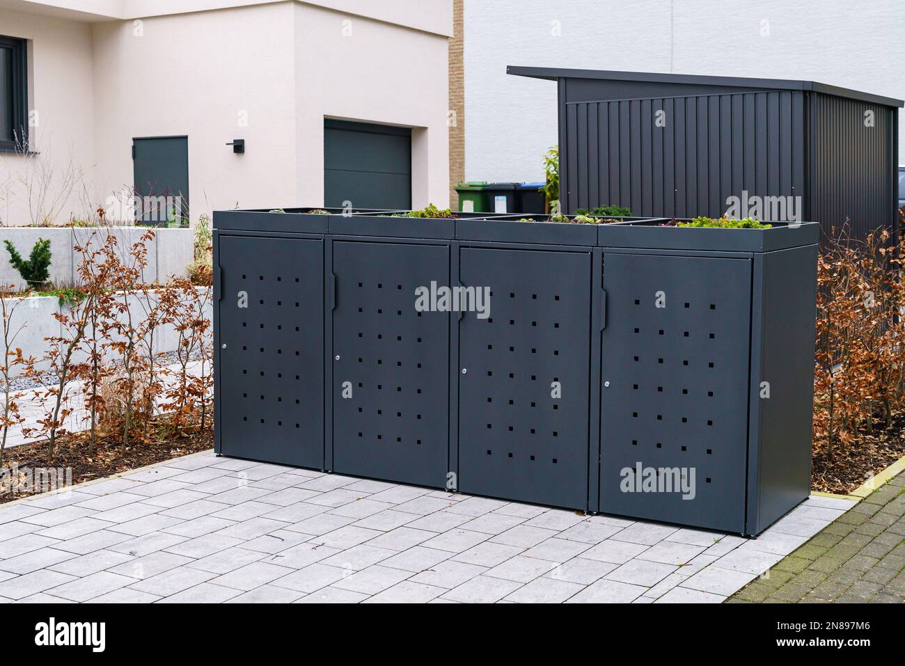 Stylish gray container for trash bins and garbage bins near residential