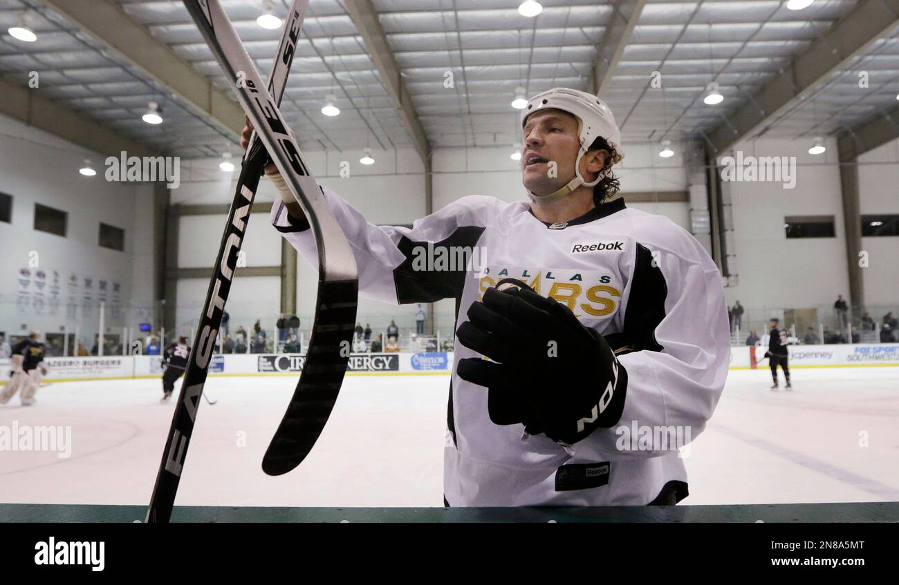 Dallas Stars left wing Brenden Morrow trades out a hockey stick during NHL hockey training camp in Frisco, Texas, Tuesday, Jan