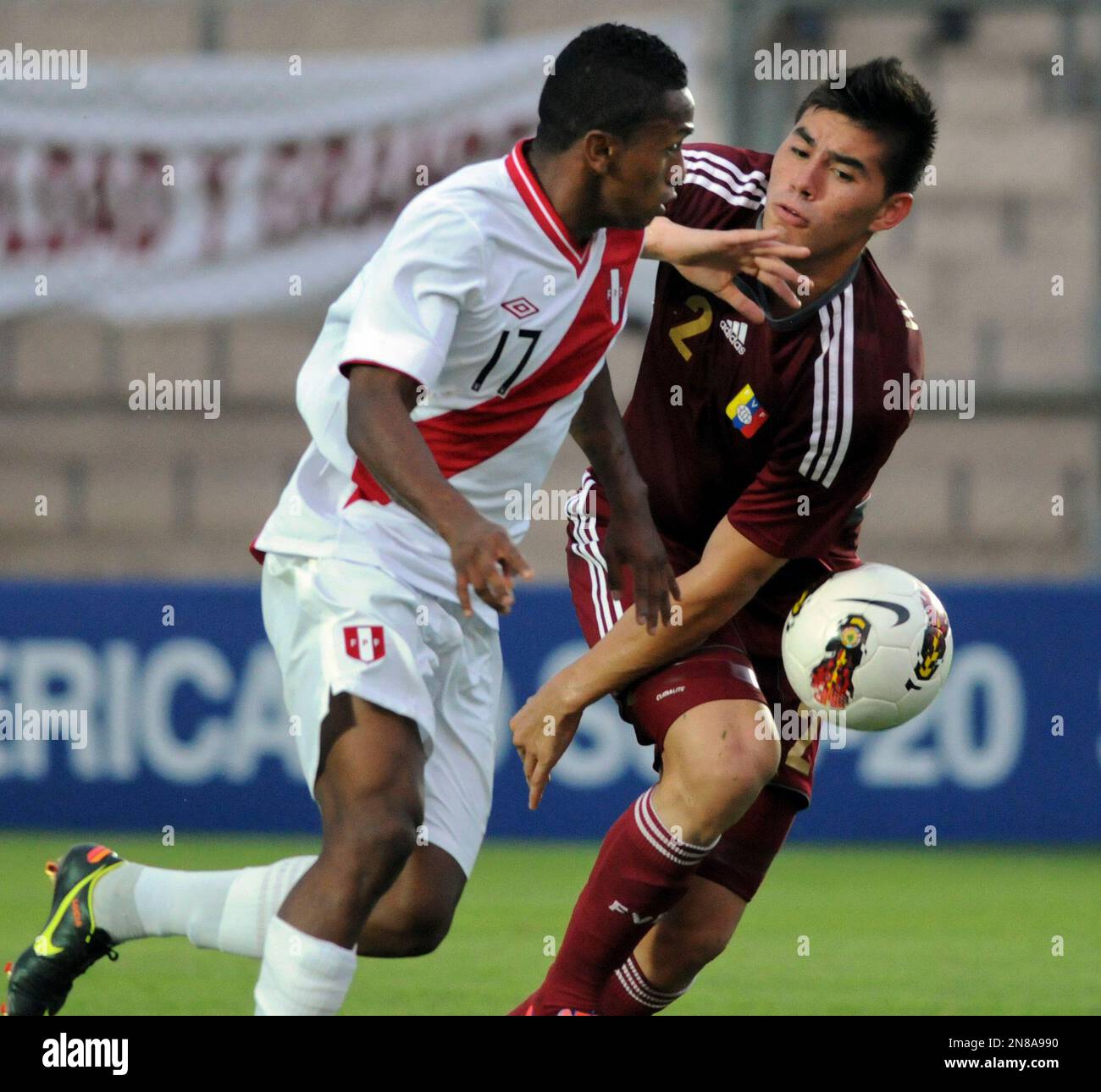 Peru's Jose Reyna, left, fights for the ball Venezuela's Angel Wilker 