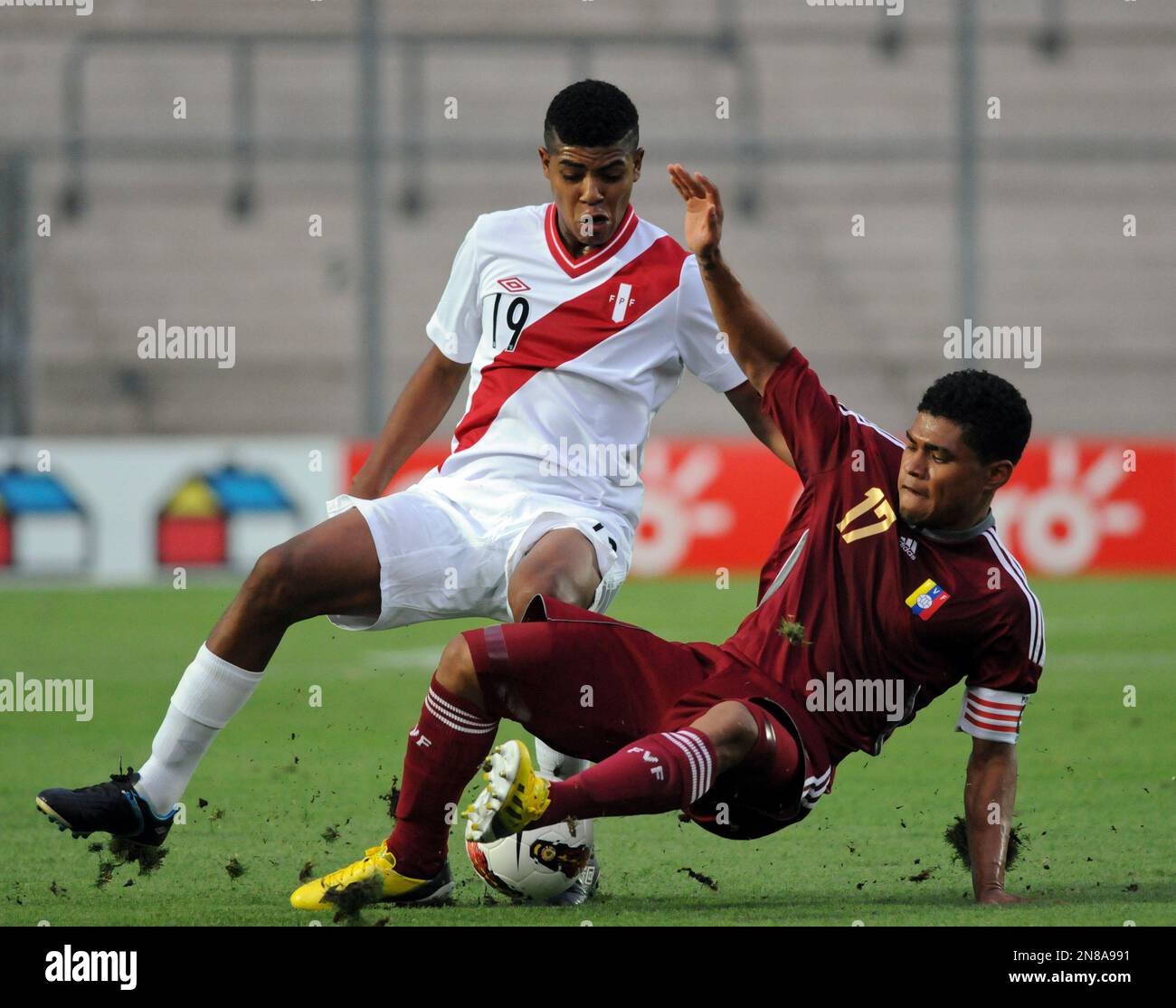 Peru's Cartagena Wilder, left, fights for the ball with Venezuela's 
