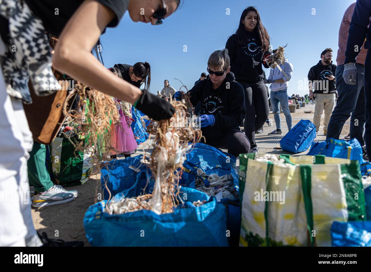 A group of volunteers separates all the waste they have collected to ...