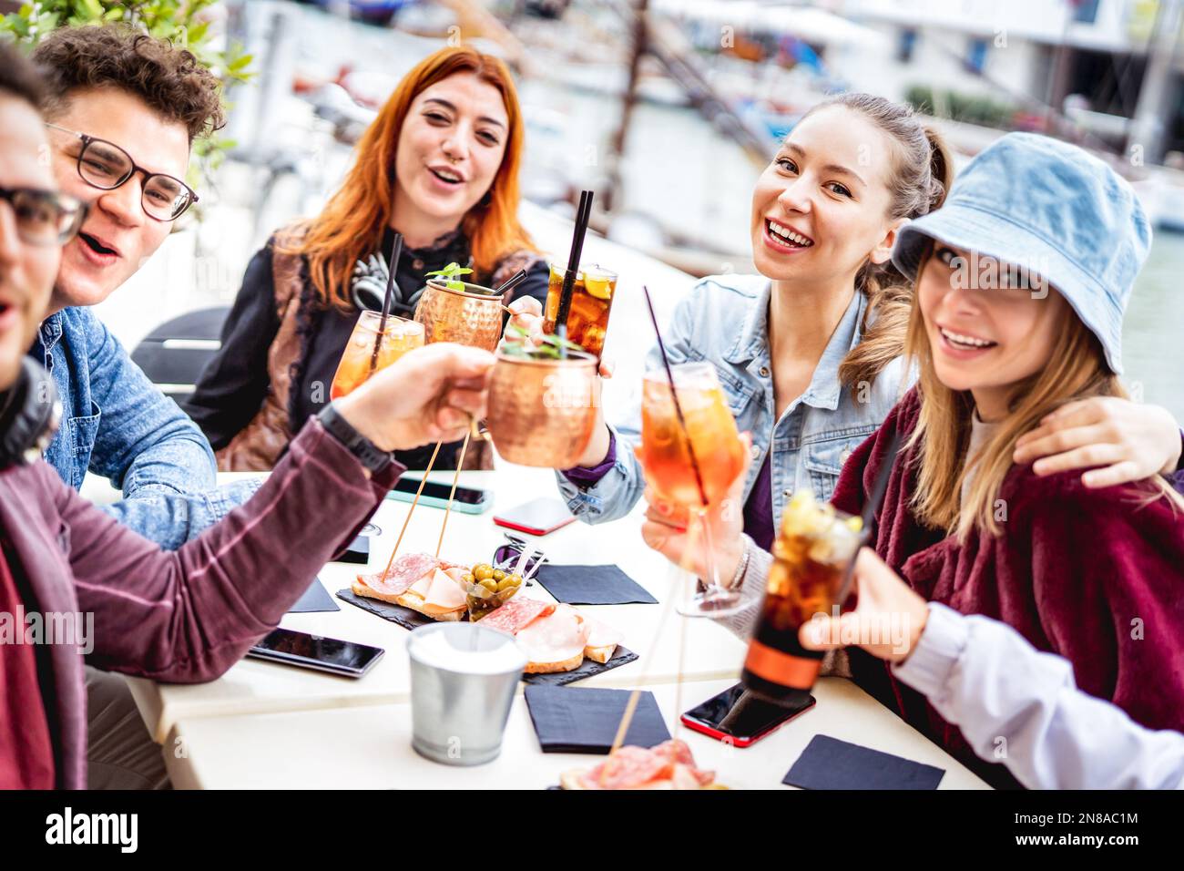 Trendy friends taking selfie at fancy restaurant out side - Life style concept with young people having fun together on happy hour at sidewalk cocktai Stock Photo