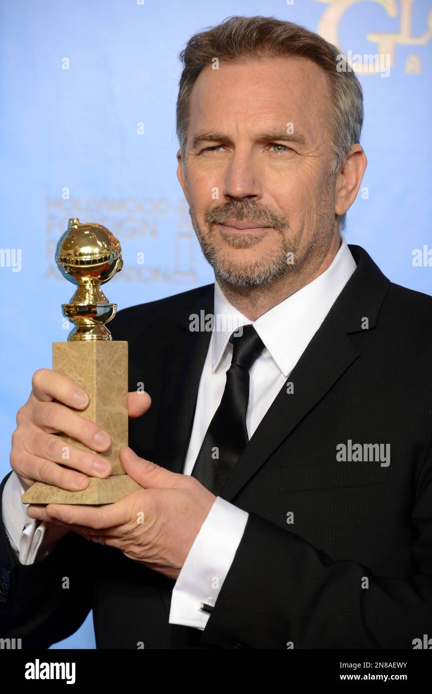 Kevin Costner poses with the award for best performance by an actor in