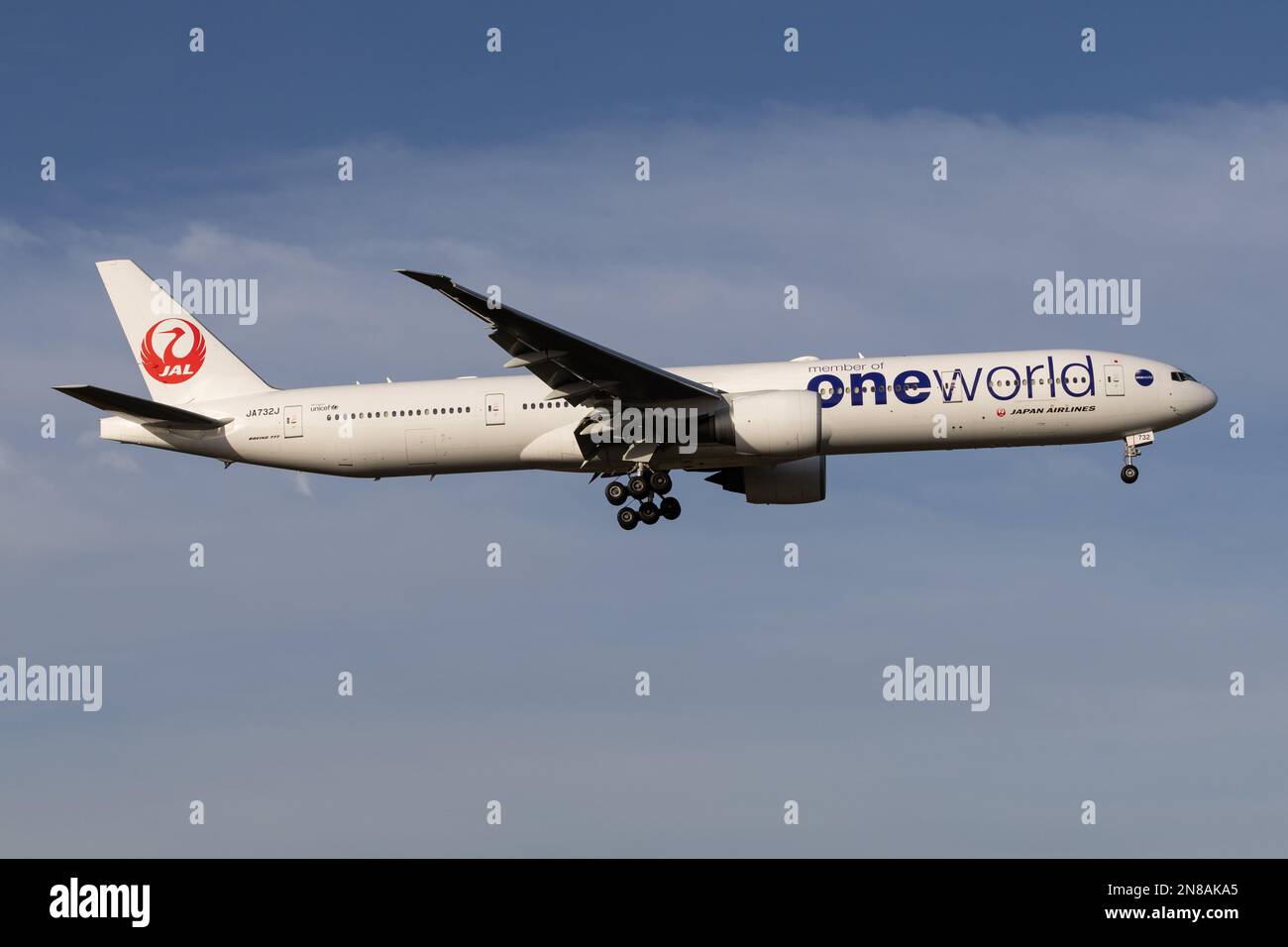 A Japan Airlines (JAL) Boeing 777, wearing a special One World livery, lands at London Heathrow Airport in 2023 Stock Photo