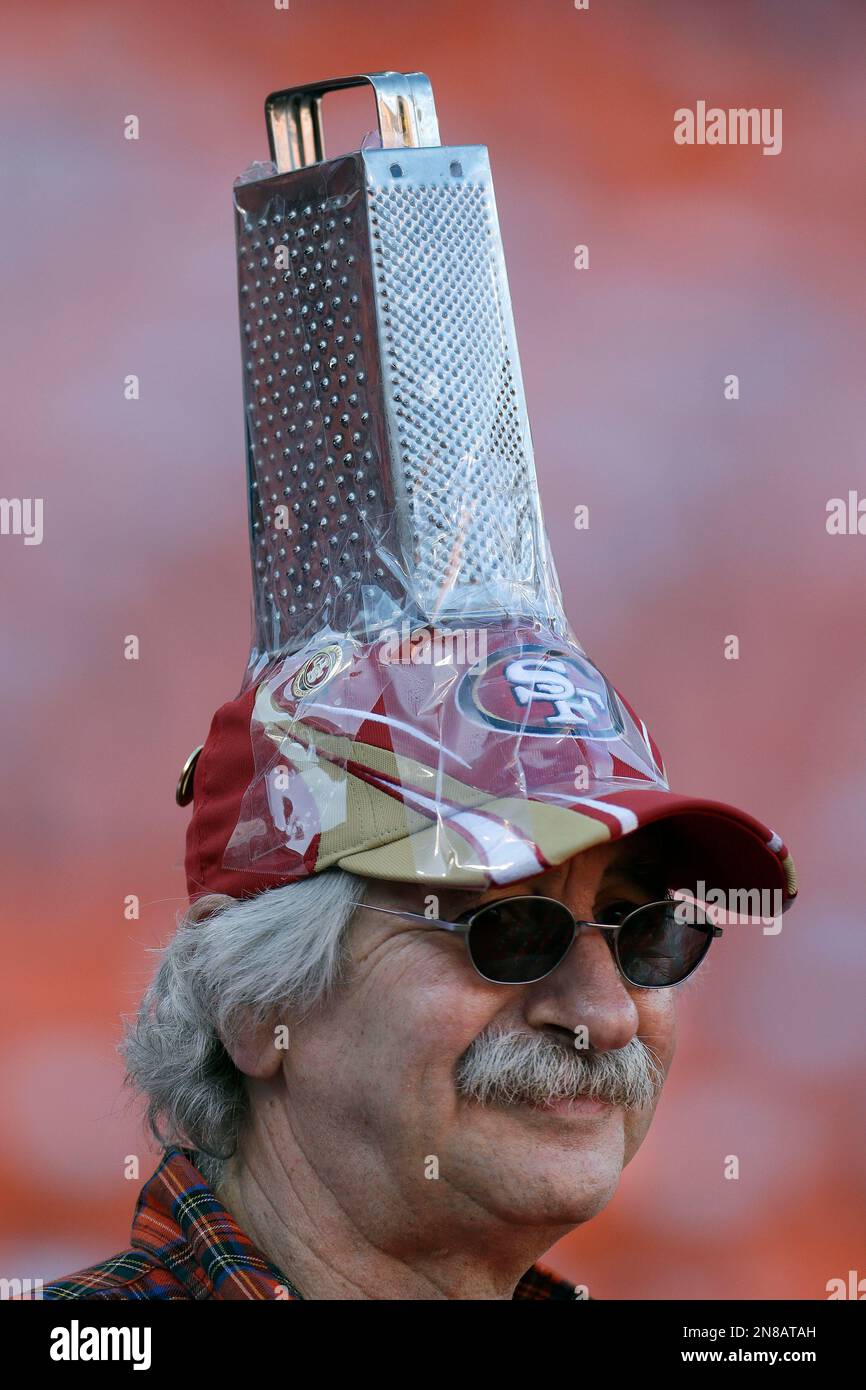 San Francisco 49ers fan John Boulos wears a cheese grater on his hat as he  watches players warm up before an NFC divisional playoff NFL football game  between the San Francisco 49ers
