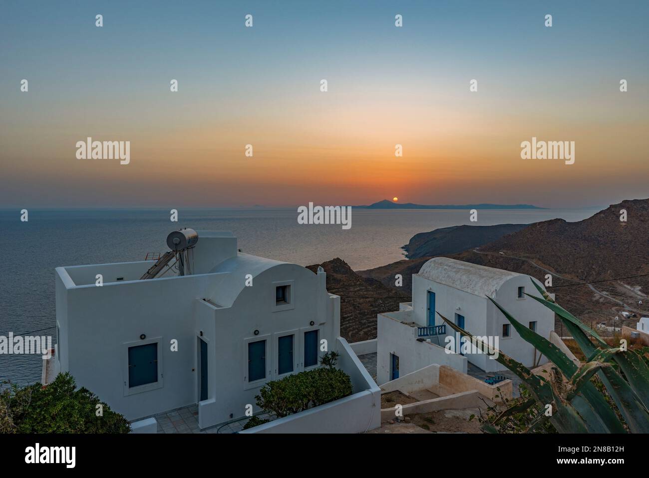 Sun setting over Santorini seen from the nearby island of Anafi Stock Photo