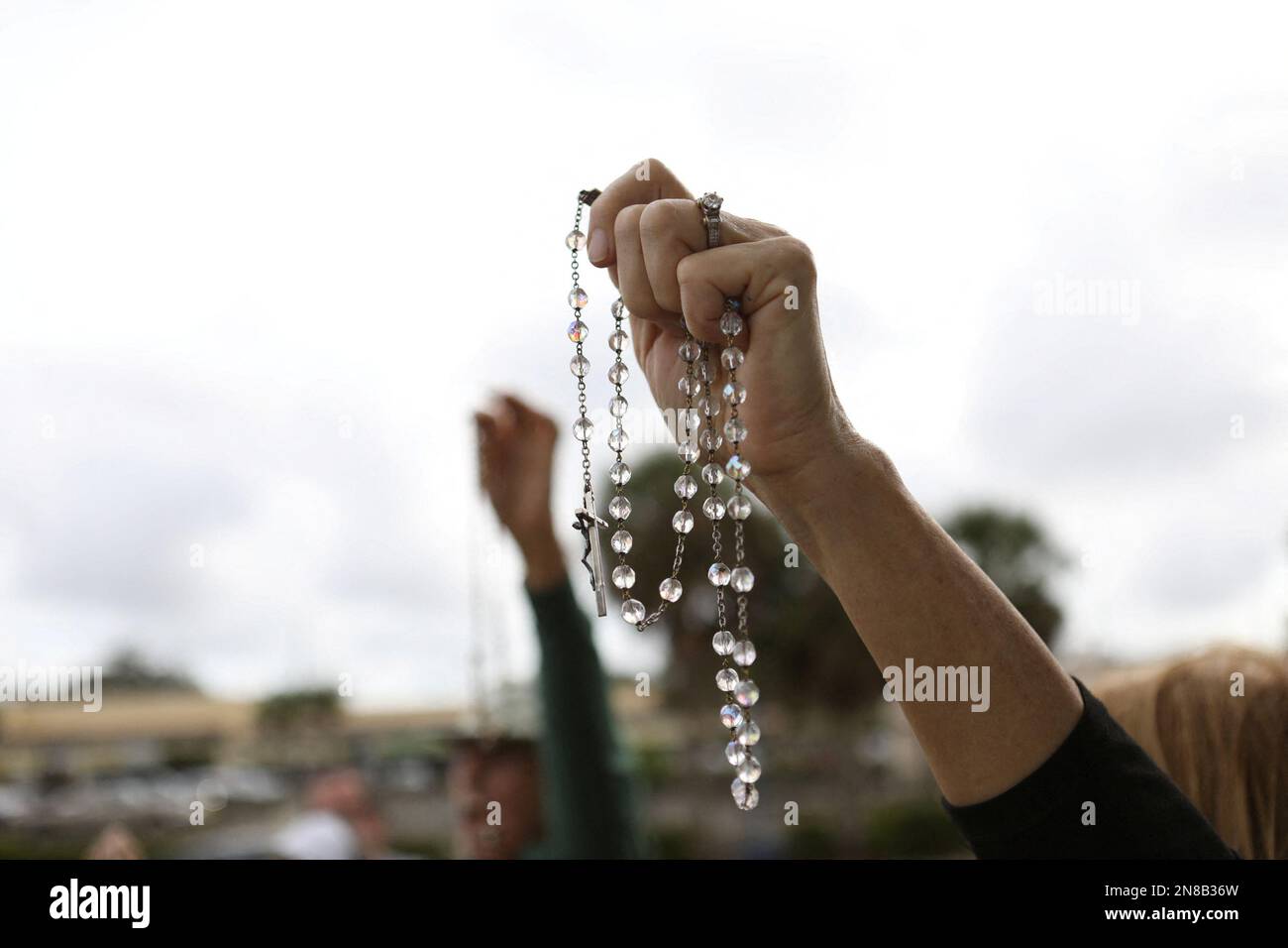 Anti-abortion activists representing their Catholic belief prays with other parishioners and protesters while they shout at patients arriving outside of the Bread and Roses Woman's Health Center, a clinic that provides abortions in Clearwater, Florida, U.S. February 11, 2023. REUTERS/Octavio Jones Stock Photo