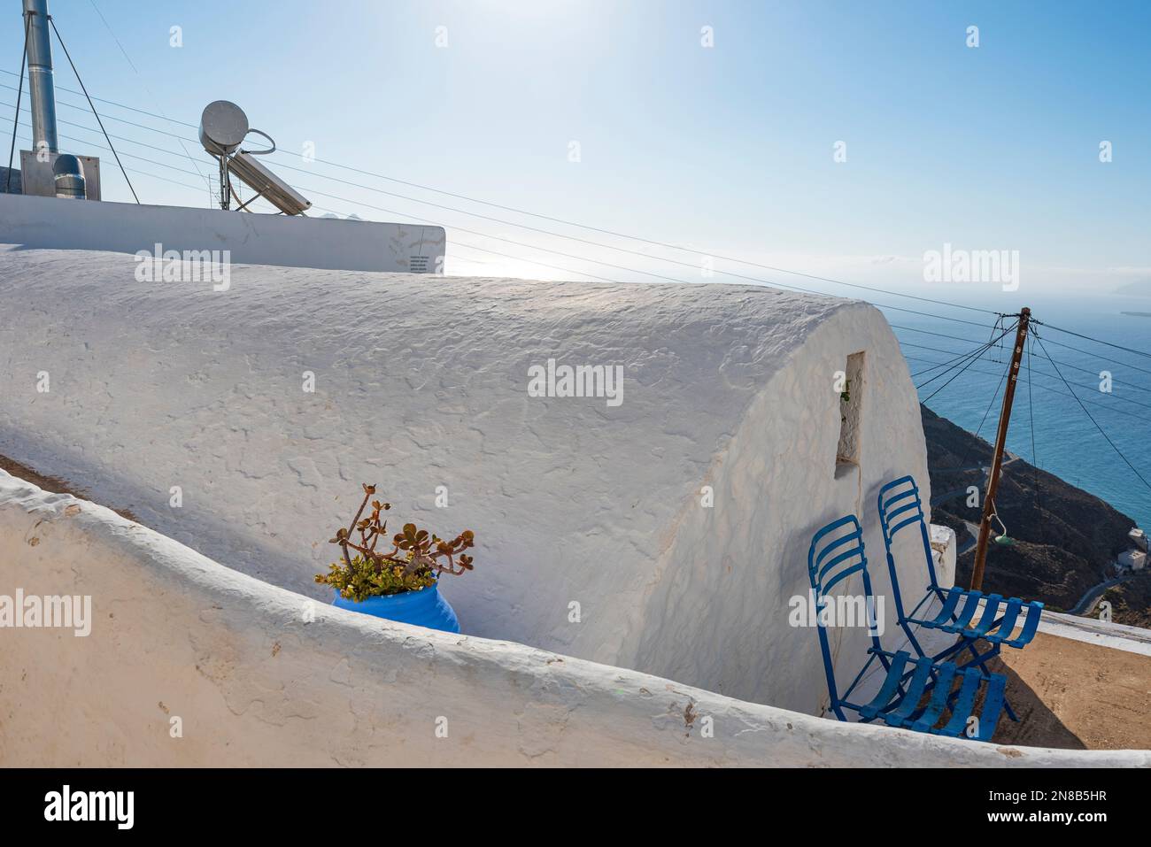 Characteristic house with chairs overlooking the sea in Chora village, Anafi Stock Photo