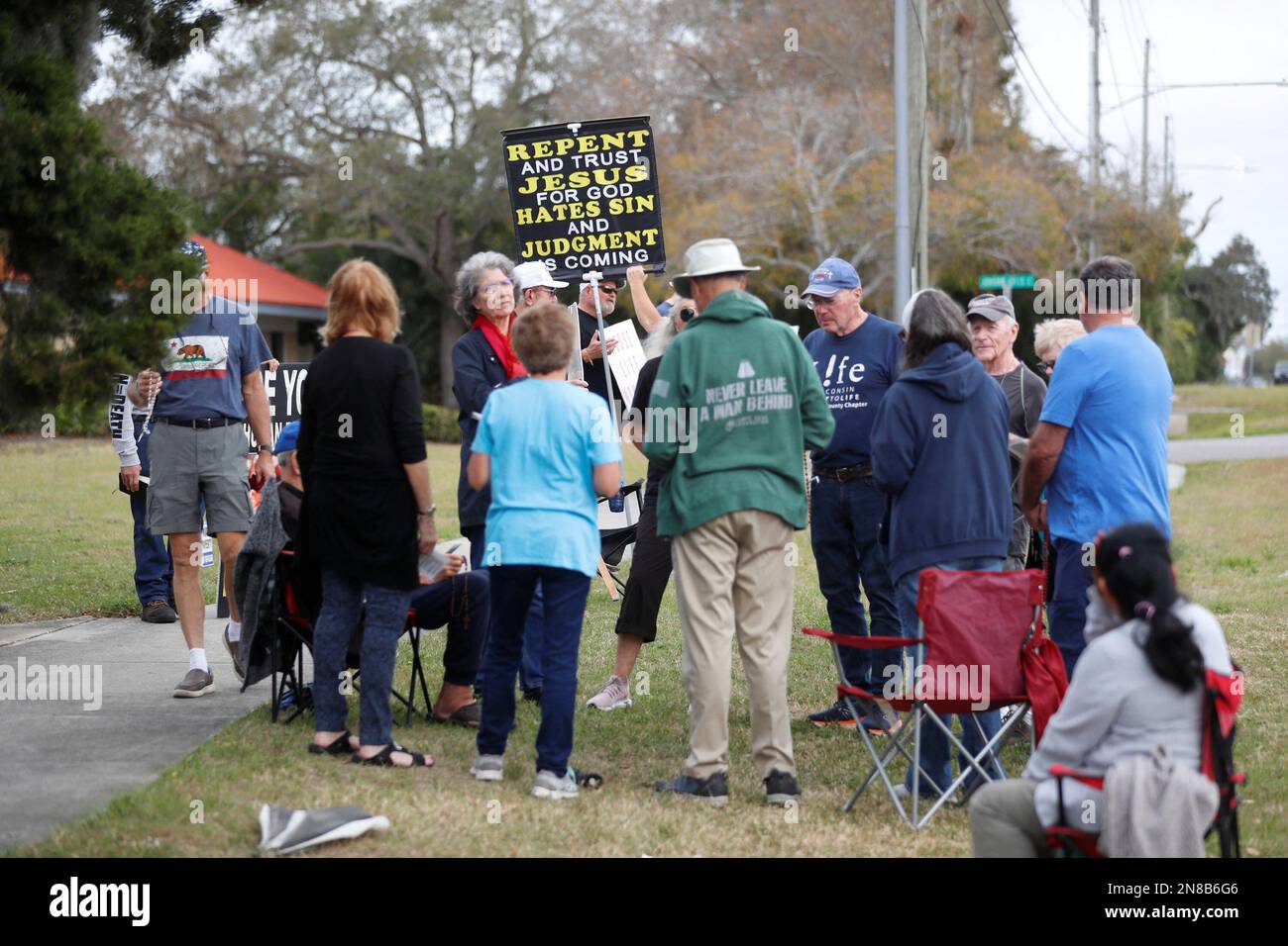 Anti-abortion activists representing their Catholic belief pray with other parishioners and protesters while they shout at patients arriving outside of the Bread and Roses Woman's Health Center, a clinic that provides abortions in Clearwater, Florida, U.S. February 11, 2023. REUTERS/Octavio Jones Stock Photo