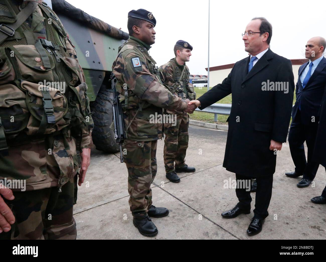 French President Francois Hollande, center, meets troops of the 12th ...