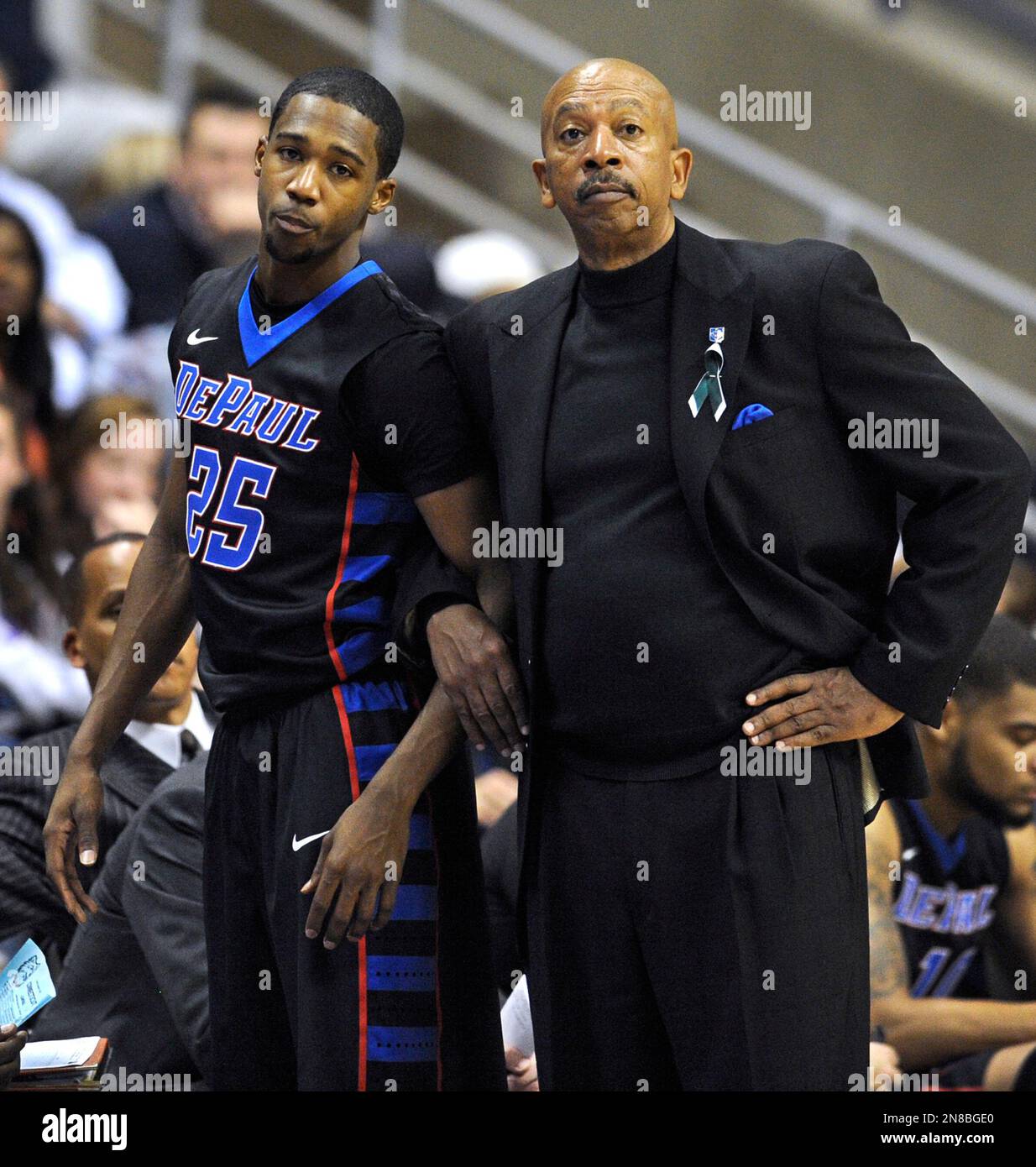 DePaul's Durrell McDonald and DePaul head coach Oliver Purnell watch