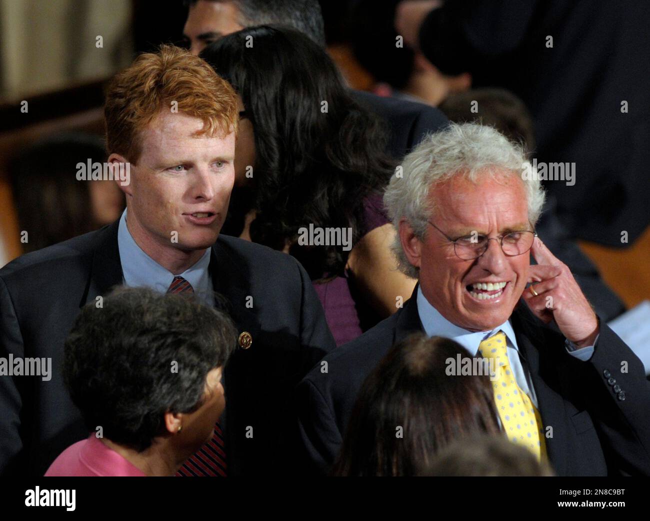 Rep.-elect Joseph P. Kennedy III, D-Mass., grandson of Robert F. Kennedy,  left, talks with his father Joseph P. Kennedy II, right, as he waits to be  sworn in as a member of