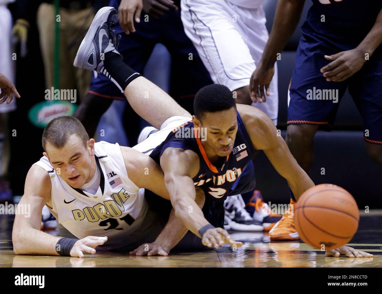 Illinois guard Joseph Bertrand, right, and Purdue forward D.J. Byrd dive for a loose ball in the