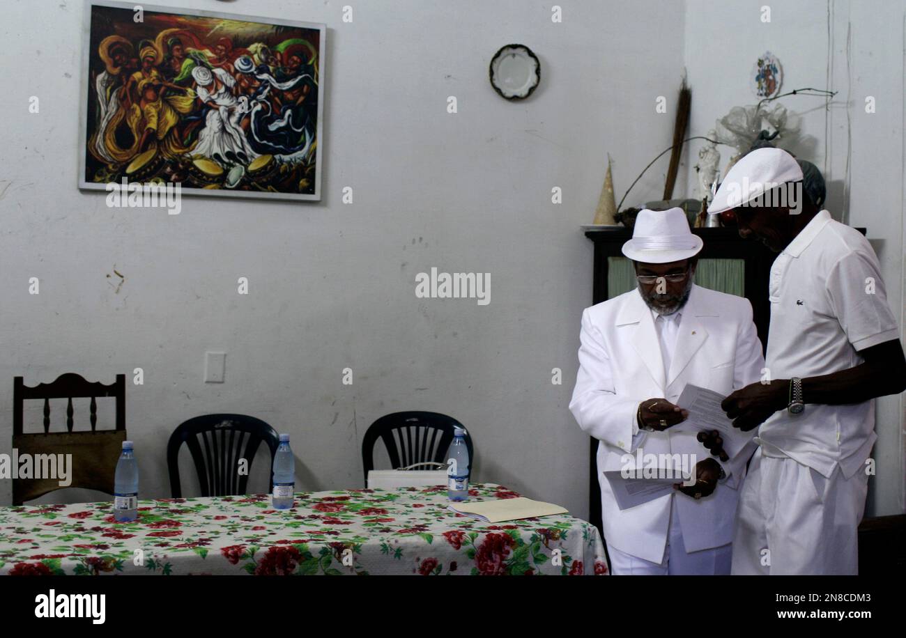 Lazaro Cuesta, an AfroCuban Santeria priest, second from right, hands