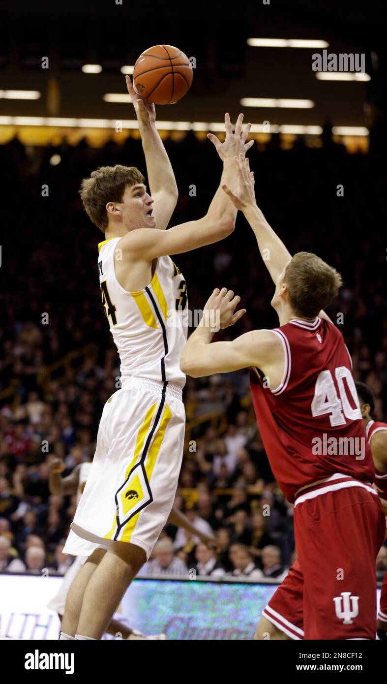 Iowa center Adam Woodbury, left, shoots over Indiana forward Cody