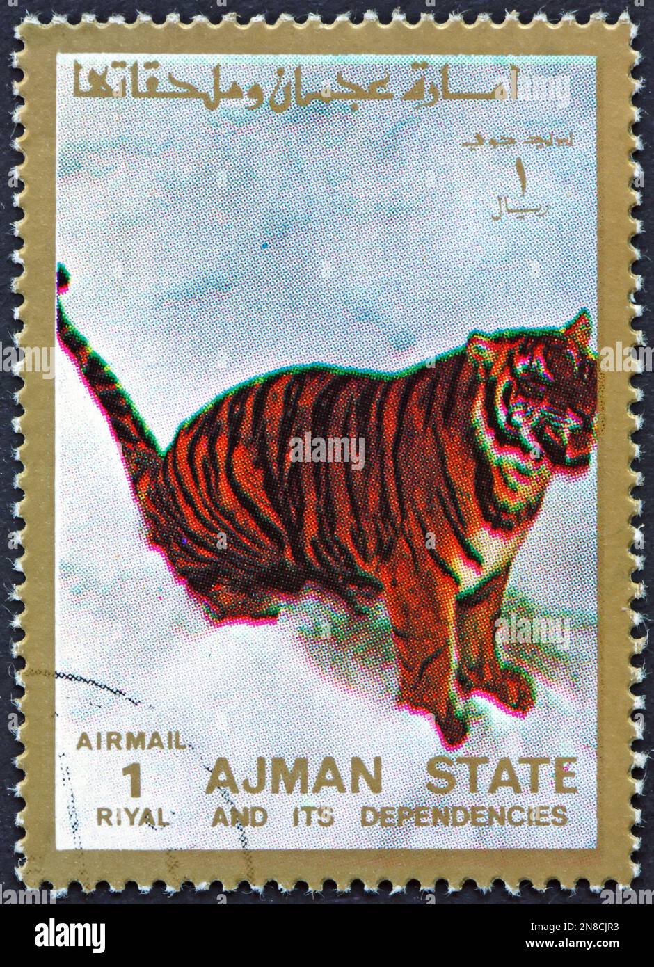 AJMAN - CIRCA 1973: a stamp printed in Ajman shows tiger, pantera tigris, big cat, circa 1973 Stock Photo