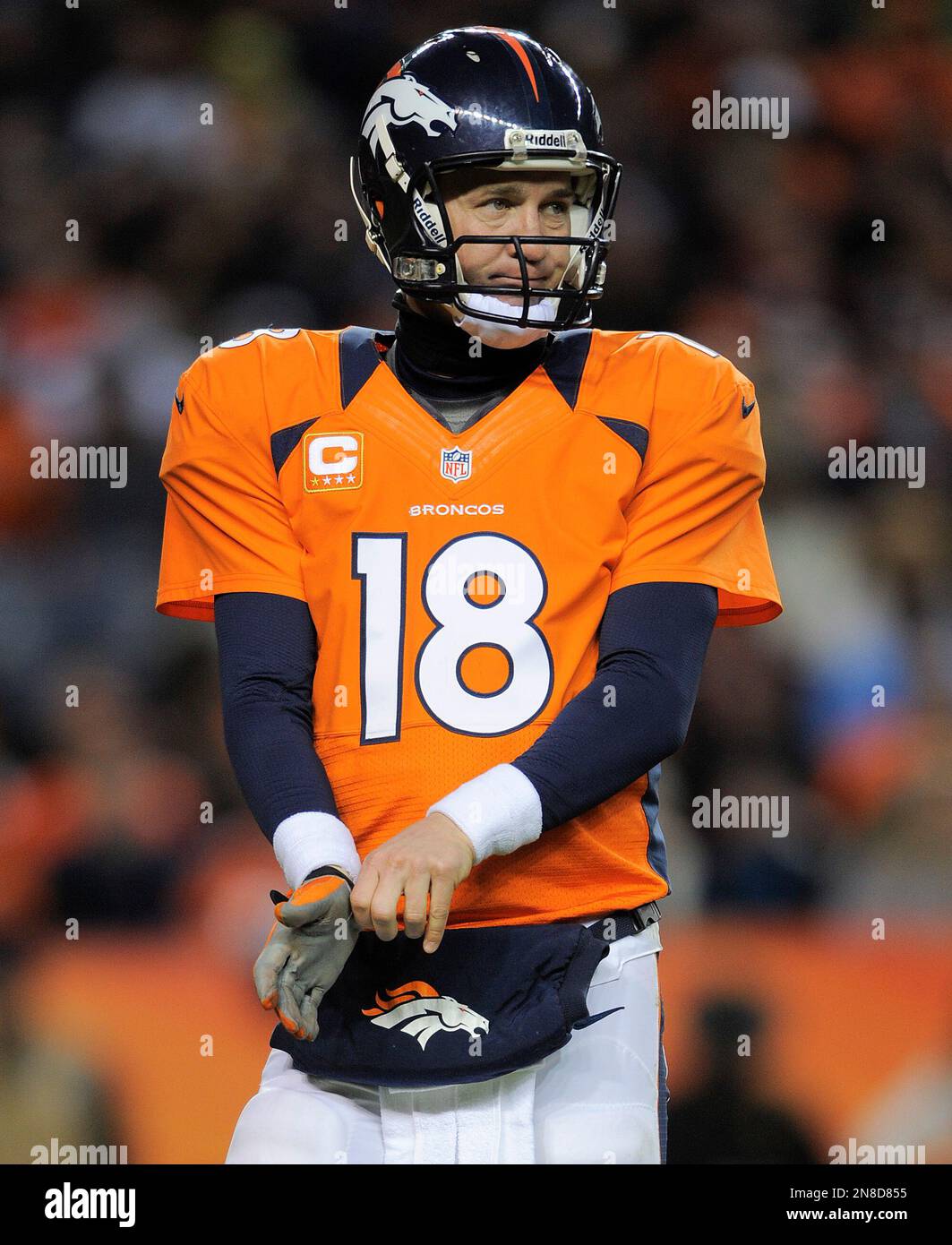 Denver Broncos quarterback Peyton Manning adjust his glove during an