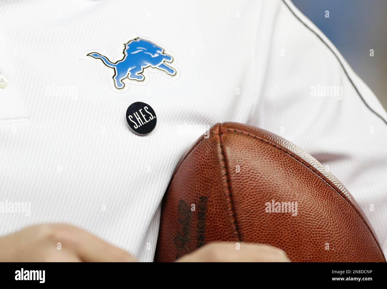 A Sandy Hook Elementary School pin is worn by a Detroit Lions assistant  coach before an NFL football game against the Atlanta Falcons at Ford Field  in Detroit, Saturday, Dec. 22, 2012. (