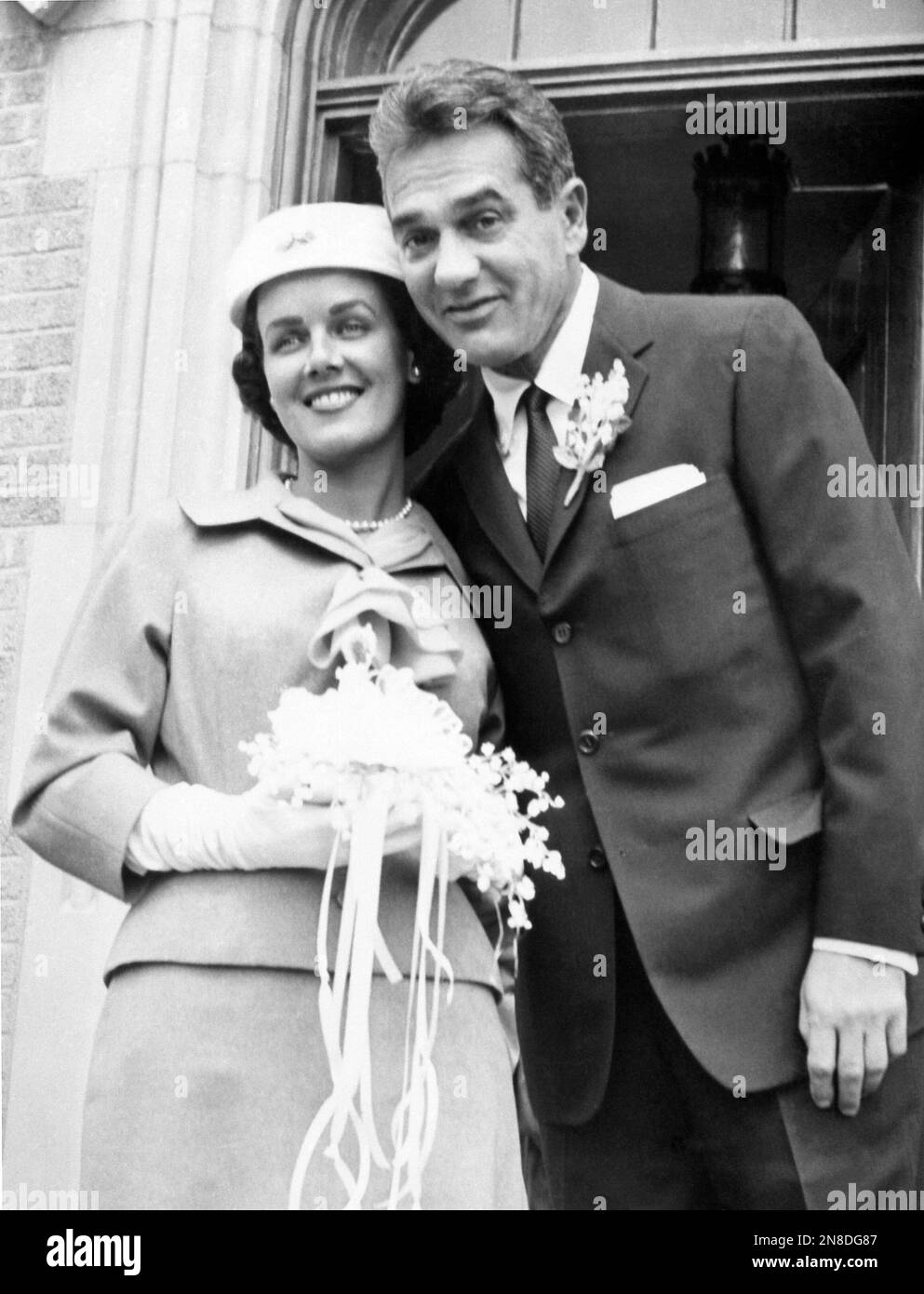 American jazz and big band drummer, orchestra leader Gene Krupa and his bride, the former Patricia A. Bowler, 25-year-old secretary of Springfield, Mass. pose on the steps of St. Dennis Roman Catholic Church in Yonkers, N.Y., United States on April 23, 1959. After their wedding Krupa and his wife will leave New York on April 25 for a honeymoon in Europe. (AP Photo) Stock Photo