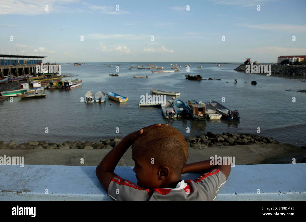 Ariel Alexis Cajar, 12, from Saboga Island, looks at fishing boats anchored  at the Panama bay in Panama City, Wednesday, Dec. 19, 2012. A poll released  Wednesday of nearly 150,000 people around