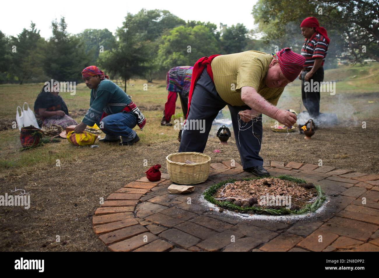 A Mayan Priest Lights A Fire At The Start Of A Ceremony At The Kaminal