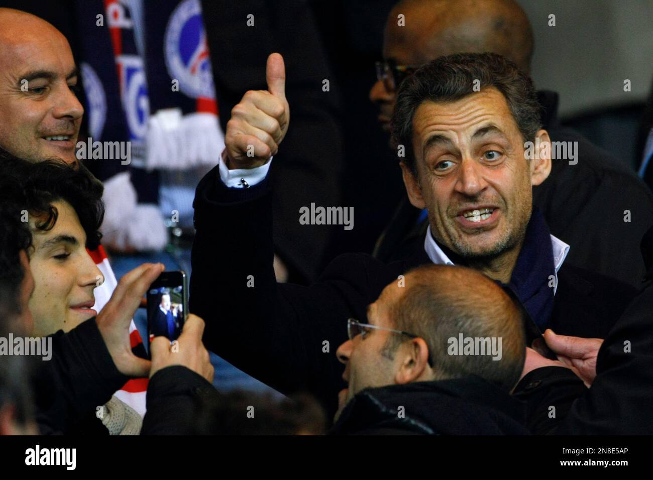 Former French President Nicolas Sarkozy, right, gives his thumb up