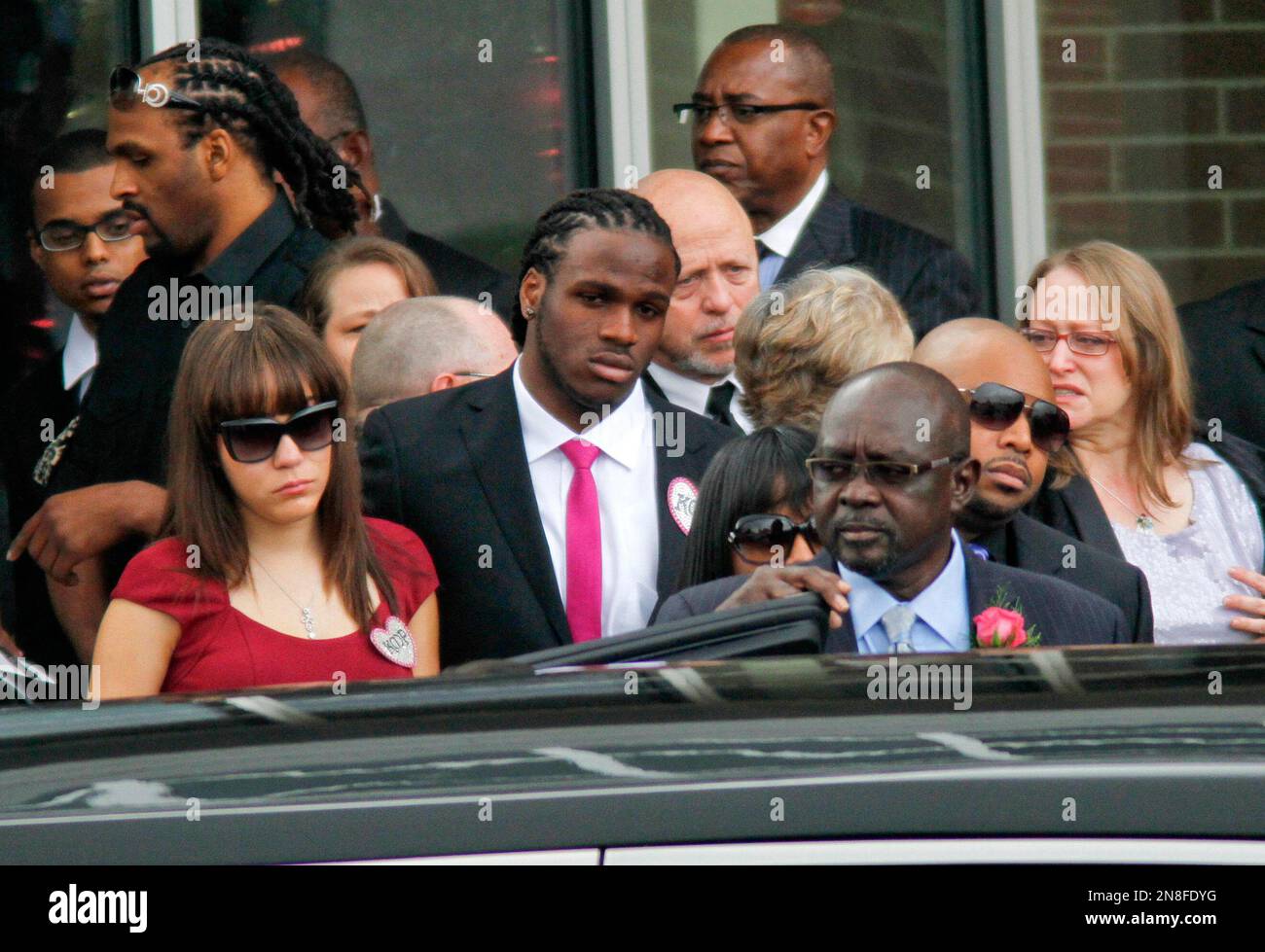 Kansas City Chiefs player Jamaal Charles, center, and wife Whitney, left,  leave the funeral service for Kasandra Perkins at the St. James Missionary  Baptist Church on Saturday, Dec. 8, 2012, in Austin,