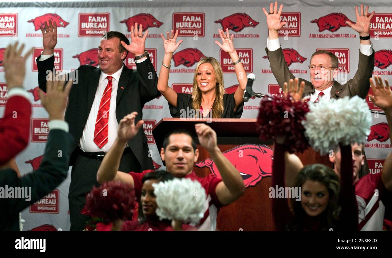 Arkansas football coach Bret Bielema, top left, his wife, Jen, center, and  athletic director Jeff Long, right, 