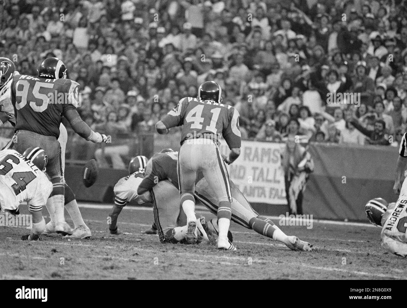 Atlanta Falcons quarterback Steve Bartkowski (10) goes down and loses the  ball as Los Angeles Rams linebacker Joe Harris sacks Bartkowski during the  overtime period in Anaheim, Dec. 21, 1980. The Rams