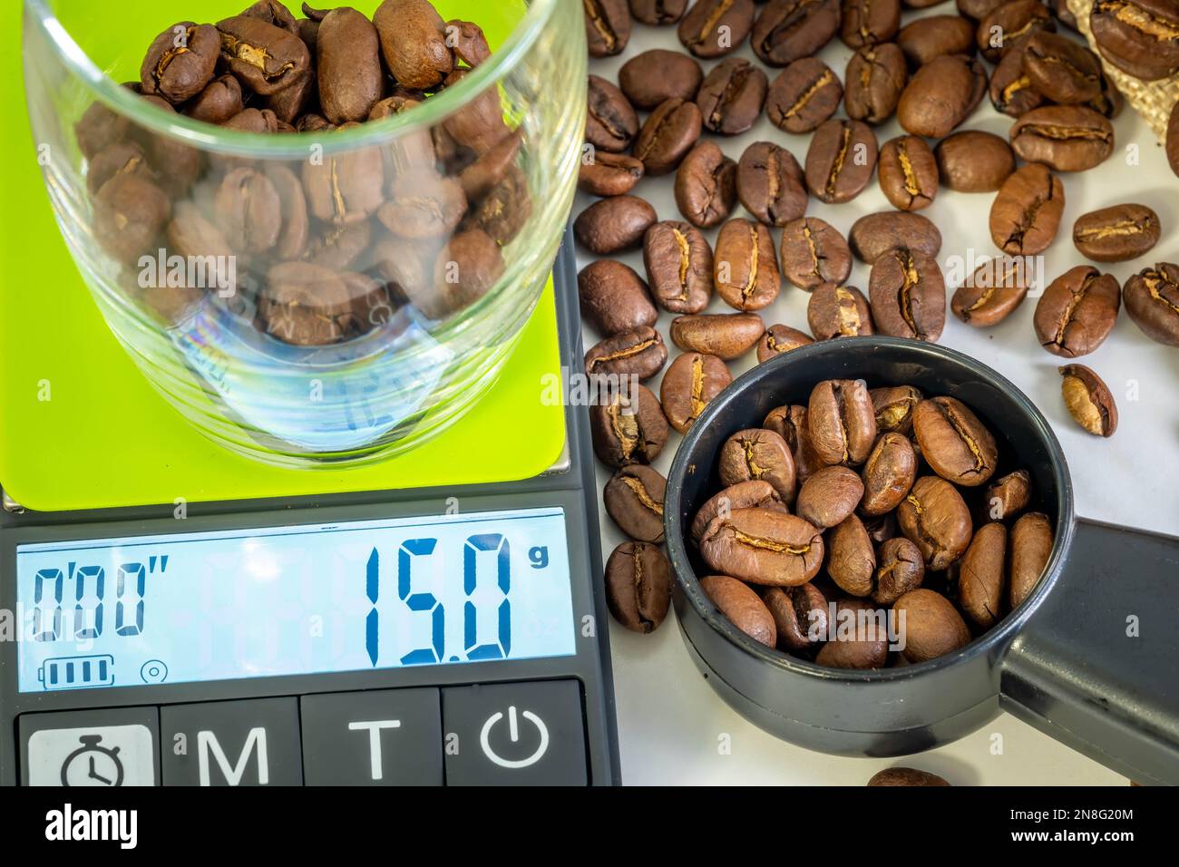 Weighting out just the right amount of coffee beans on a scale for a