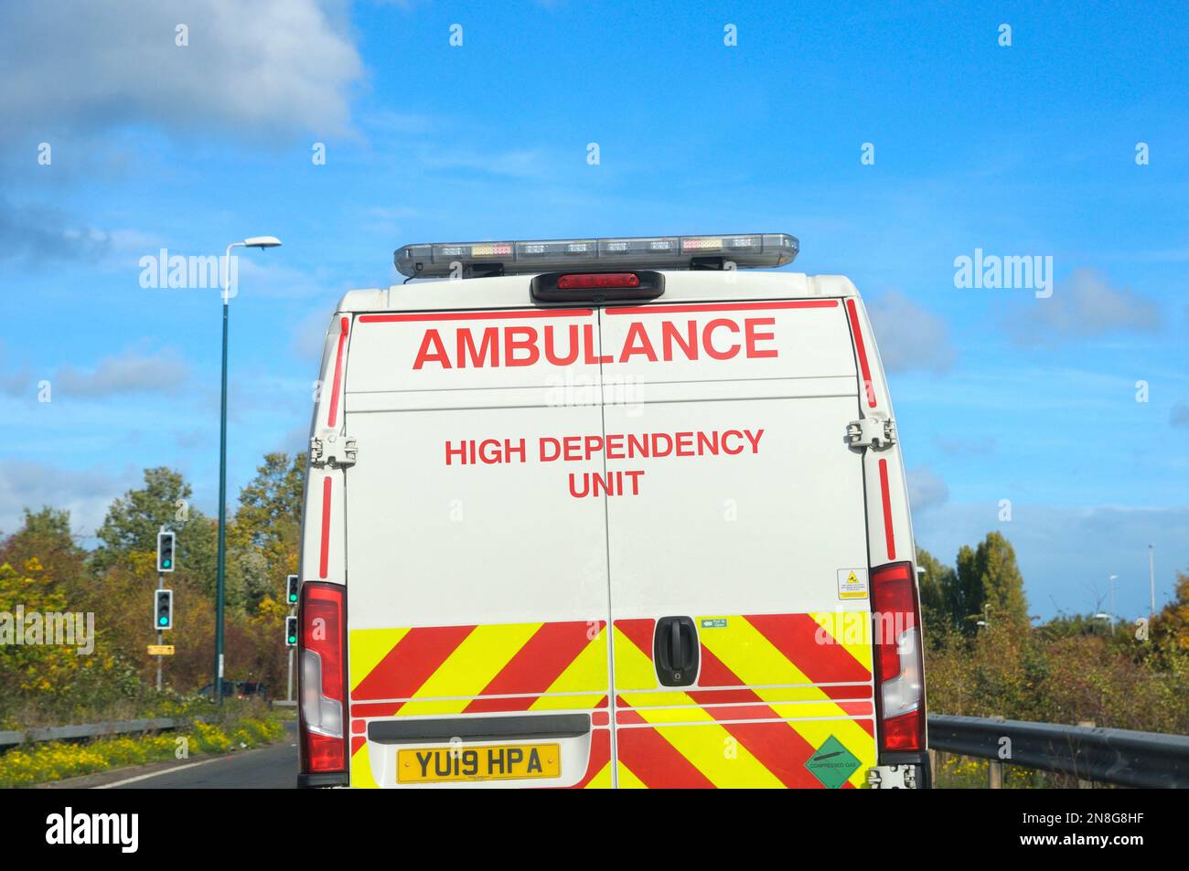 A High Dependency Unit white ambulance van driving on a UK motorway Stock Photo