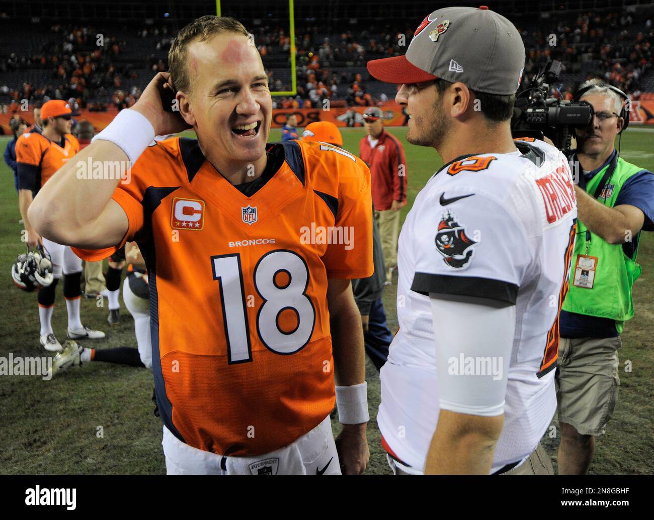 Denver Broncos quarterback Peyton Manning (18) talks with Tampa Bay